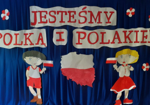 i dziewczynka z flagami Polski, w strojach biało-czerwonych i napis "Jesteśmy Polką i Polakiem"