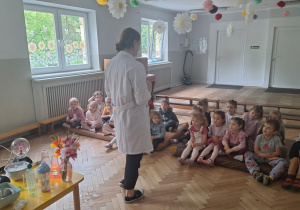 Prowadząca opowiada dzieciom o suchym lodzie